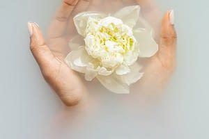 gentle woman with flower in hands