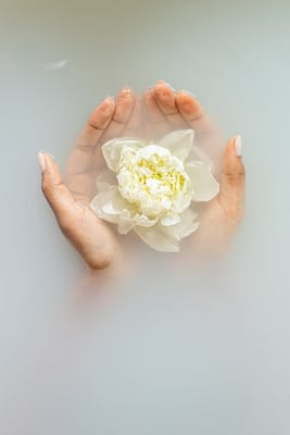 gentle woman with flower in hands